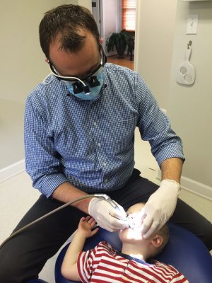 Dr. Draper Working on a Child